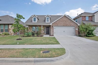 View of front of property featuring a front yard and a garage | Image 1