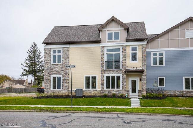 View of front of house with a balcony, a front lawn, and central air condition unit | Image 32