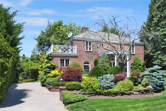 View of front of home with a chimney, a balcony, and brick siding | Image 22