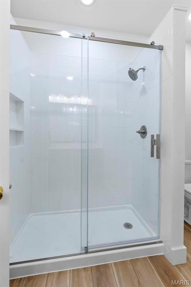 Bathroom with toilet and a tile shower with door | Image 13