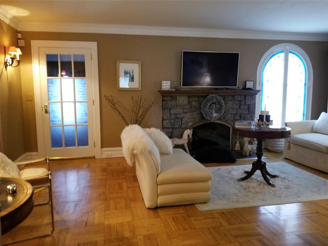 Living room featuring baseboards, a fireplace, and crown molding | Image 4