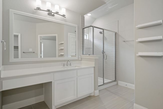 Full bath featuring tile patterned floors, vanity, a stall shower, and baseboards | Image 19