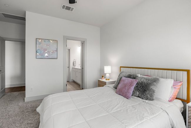 The primary suite is conveniently located on the main level, away from the secondary rooms upstairs. | Image 12