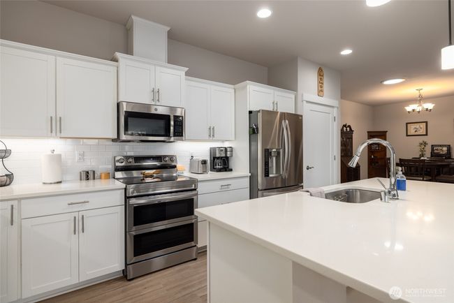 The island has an undermount sink and dishwasher. | Image 15