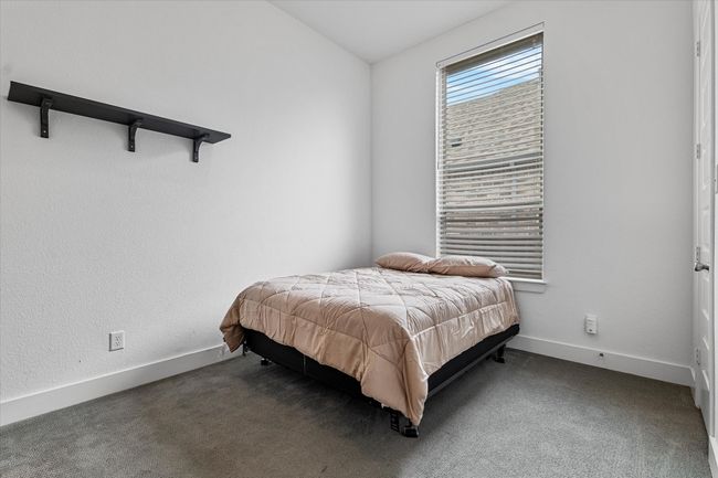 Bedroom featuring baseboards and dark colored carpet | Image 19
