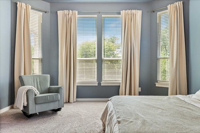 Carpeted bedroom with multiple windows and baseboards | Image 19