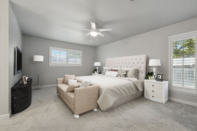 Bedroom featuring baseboards, light carpet, and ceiling fan | Image 22