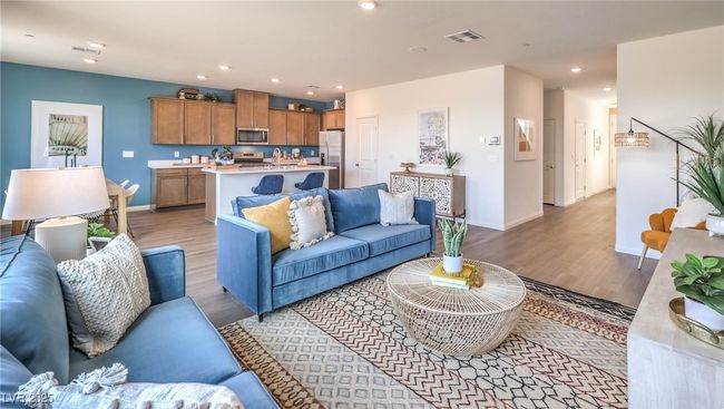 Photo is representational only; actual home finishes may vary. Living room with light wood-style flooring, baseboards, and recessed lighting | Image 5