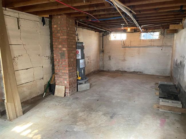 Below grade area featuring water heater | Image 5