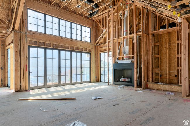 Unfurnished living room featuring a high ceiling | Image 8