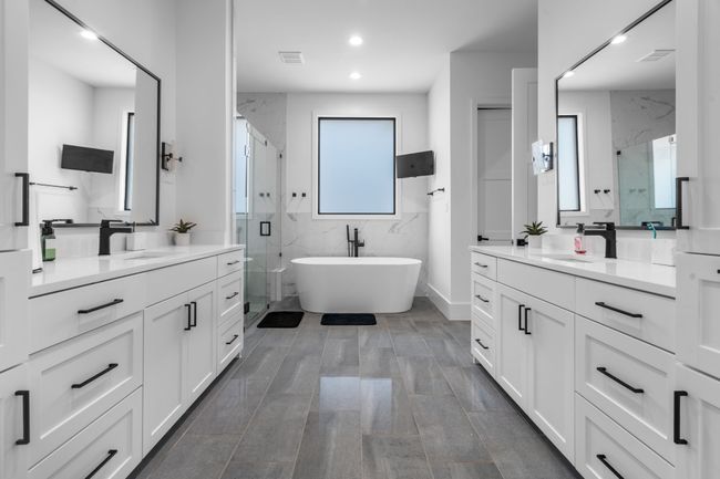 Full bathroom with a marble finish shower, two vanities, a soaking tub, and recessed lighting | Image 15
