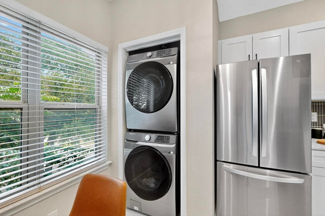 Washroom with stacked washer and clothes dryer | Image 14