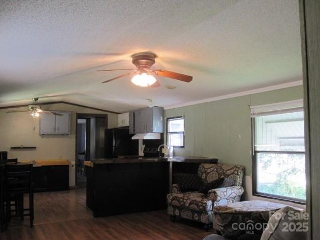 Open floor plan has kitchen dining and living room. | Image 12