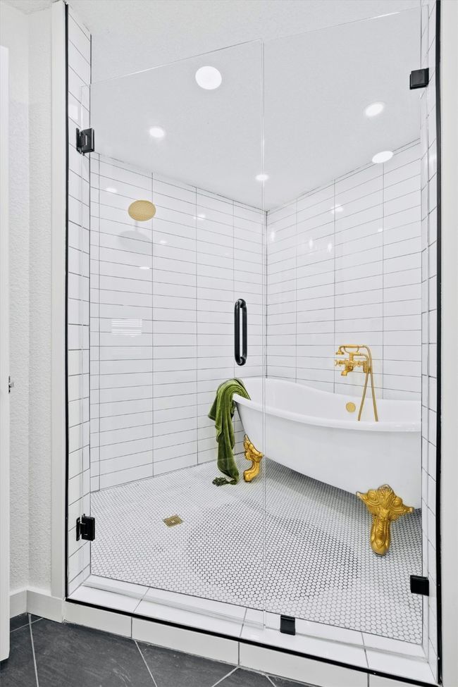 Bathroom featuring a freestanding tub, a stall shower, tile patterned floors, and recessed lighting | Image 22
