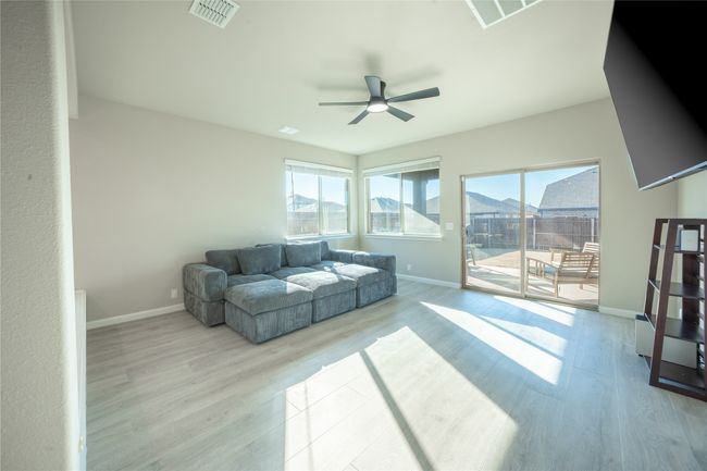 Living room featuring ceiling fan and light hardwood / wood-style floors | Image 12