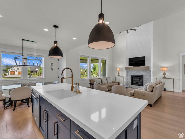 Kitchen featuring a sink, healthy amount of natural light, light wood-type flooring, recessed lighting, and a high ceiling | Image 15