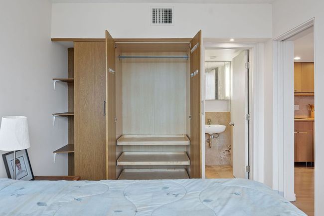 Slide out shelving in the oversized closet and an ensuite bath. | Image 15