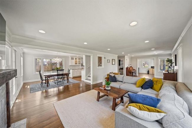 Living area featuring ornamental molding, recessed lighting, stairway, and baseboards | Image 5