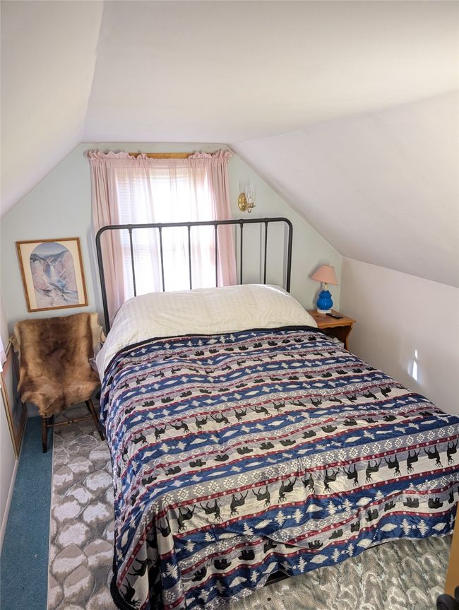 Carpeted bedroom featuring lofted ceiling | Image 11