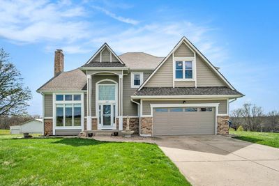 Craftsman house featuring a front lawn and a garage | Image 1