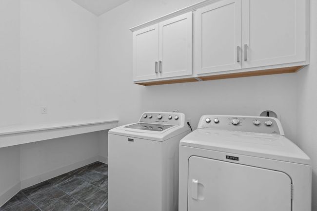 The in home laundry room comes with a convenient folding counter top with space for bins underneath. | Image 28