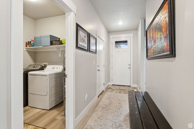 Laundry area with light wood-type flooring and washer and dryer | Image 9