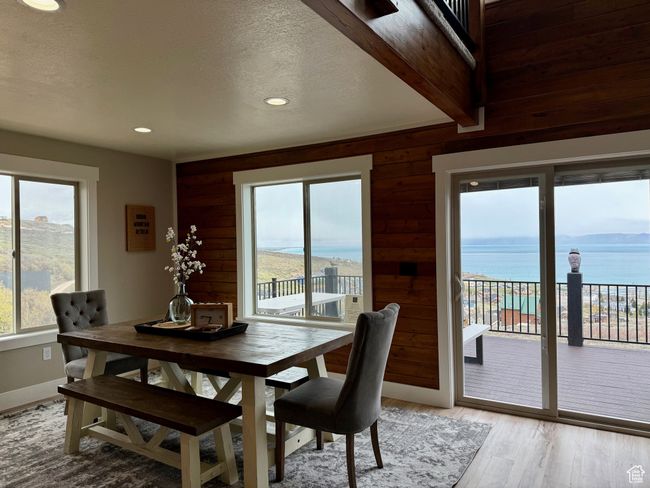 Dining space with wooden walls, light wood-style floors, recessed lighting, and a textured ceiling | Image 23