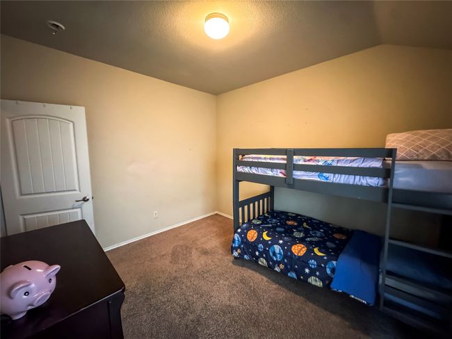 Bedroom featuring carpet flooring, baseboards, and vaulted ceiling | Image 16