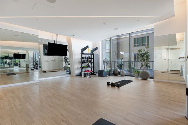 Workout area featuring expansive windows and light wood finished floors | Image 26