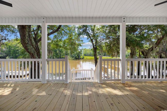 Deck featuring a water view and view of wooded area | Image 27