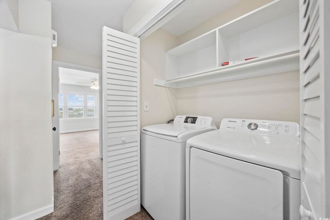 Laundry area featuring independent washer and dryer, carpet flooring, and a ceiling fan | Image 29