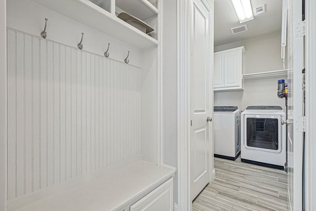 Drop space for bags and backpacks with peek at Utility Room. | Image 22
