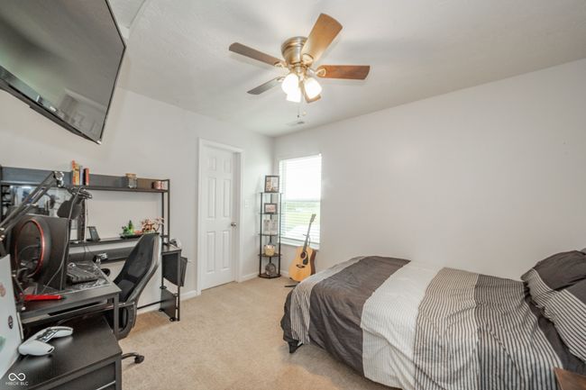 bedroom featuring a desk, carpet, ceiling fan, and baseboards | Image 28