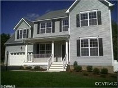 View of front of property featuring covered porch and a garage | Image 1