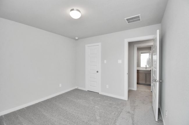 Generously sized secondary bedrooms featuring spacious closets, soft and inviting carpeting underfoot, large windows allowing plenty of natural light, and the added touch of privacy blinds for your personal retreat. | Image 35