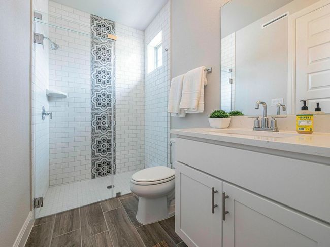 Bathroom with vanity, a stall shower, and wood finish floors | Image 23