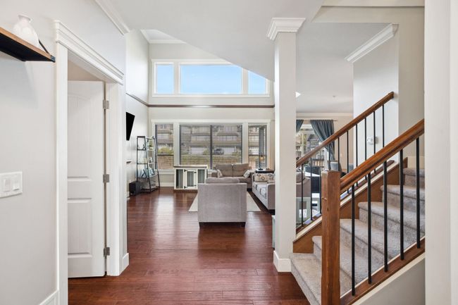 Foyer featuring a wealth of natural light, dark wood-type flooring, and ornamental molding | Image 13