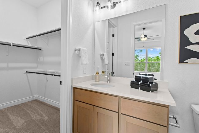 Bedroom 1 ensuite bathroom with vanity, ceiling fan, and a spacious closet | Image 23