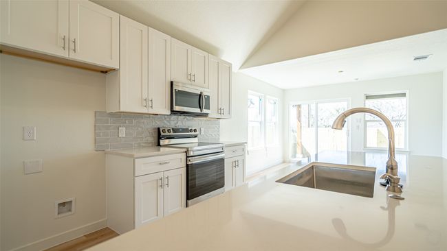 Large kitchen island with huge sink and breakfast bar | Image 15