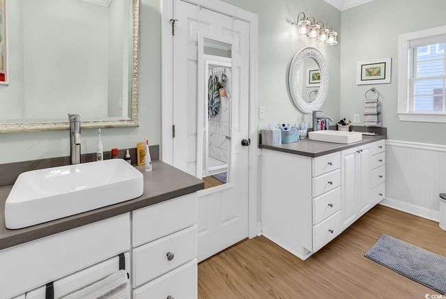 Bathroom featuring crown molding, vanity, and hardwood / wood-style flooring | Image 22
