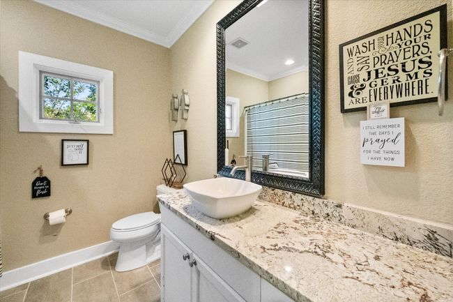 Bathroom with ornamental molding, toilet, vanity, baseboards, and tile patterned floors | Image 21