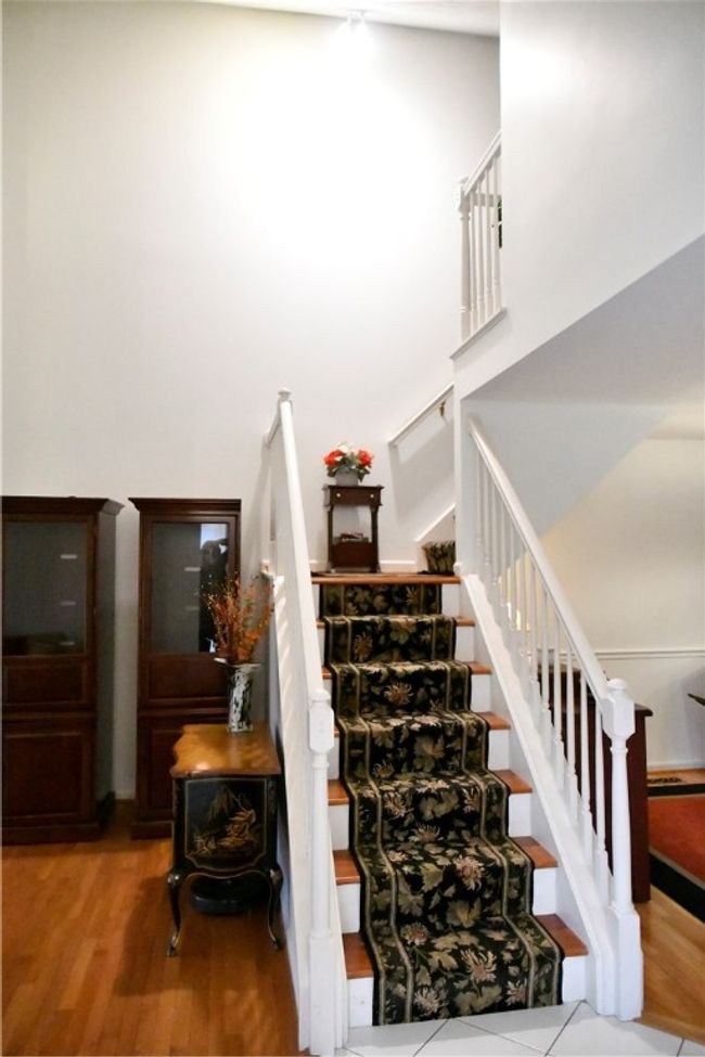 Opposite the entry is the staircase to the loft bedroom and storage | Image 8