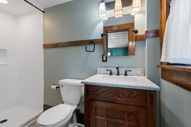 Full bathroom featuring toilet, a stall shower, and vanity | Image 17