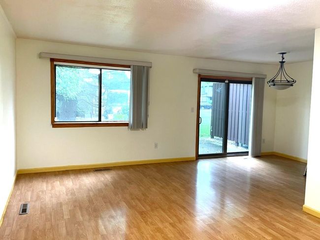 Empty room featuring plenty of natural light and light wood-style flooring | Image 4