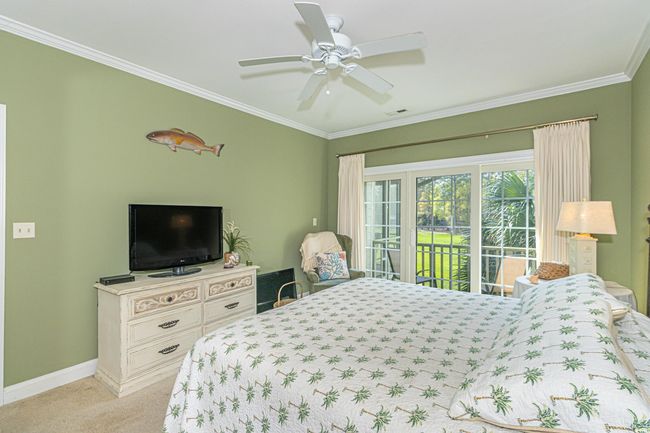 Bedroom featuring baseboards, access to exterior, ornamental molding, and light colored carpet | Image 16