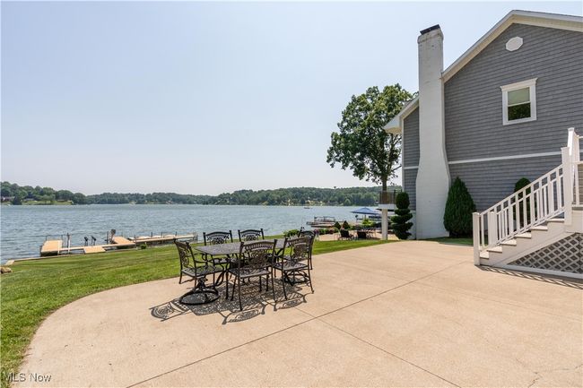 View of patio with a water view and stairs | Image 16