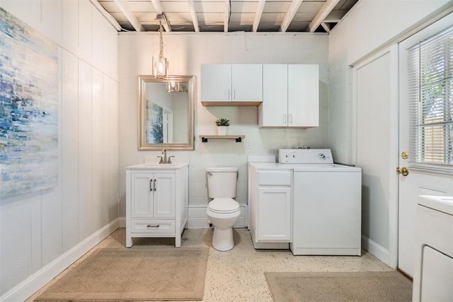 Half bath with laundry facilities adjacent to primary bedroom | Image 15