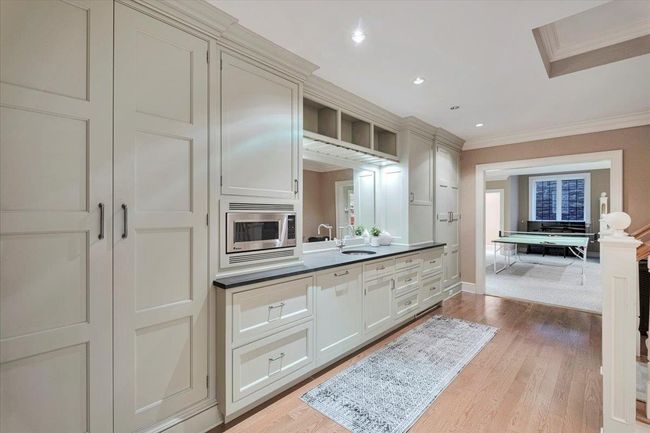 Basement with high-end kitchen, Subzero refrigerator and freezer, abundant storage and recessed lighting. | Image 20