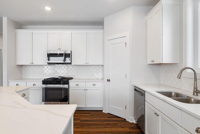 This gorgeous kitchen features a convenient walk-in pantry with ample storage space, perfect for keeping everything organized, well-stocked, and easily accessible for a tidy and efficient kitchen. | Image 19