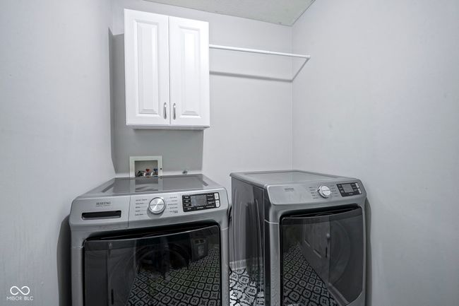 laundry area featuring independent washer and dryer and cabinet space | Image 29